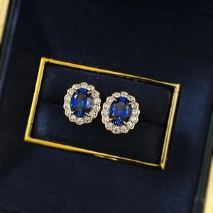 Royal blue oval sapphire stud earrings with diamond halo and gold plating