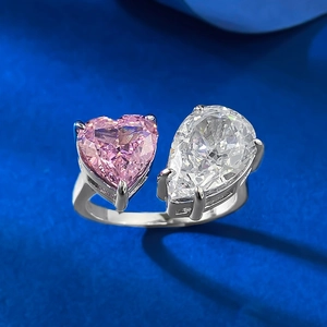 Close-up of radiant pink heart and white pear cut stones on adjustable silver ring