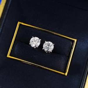 Close-up of classic 1-carat round stud earrings in silver four-prong setting