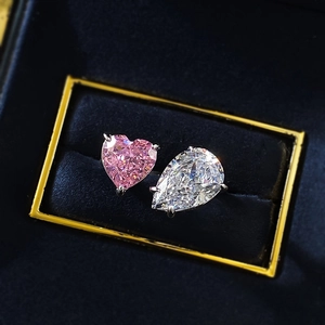 Toi et Moi ring featuring pink heart and pear cut high carbon diamonds on silver band