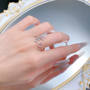 Detail of 925 silver adjustable ring with pink pear-cut stone and fan-shaped diamonds