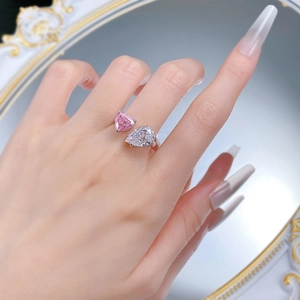 Elegant silver open ring with pink heart and white pear cut stones worn on hand