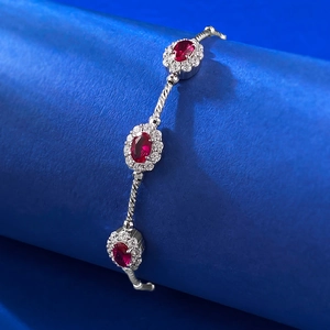 Elegant S925 silver bracelet with oval red gemstones and white crystals on blue background