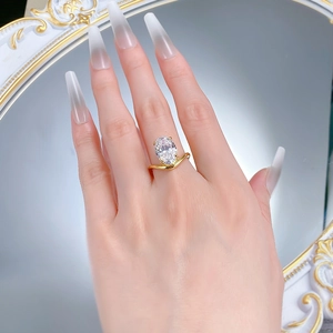 Close-up of S925 silver V-shaped gold ring featuring a large oval-cut clear cubic zirconia