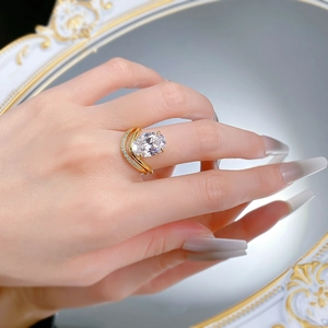 Macro view of gold-plated double-band ring with a large oval-cut sparkling gemstone
