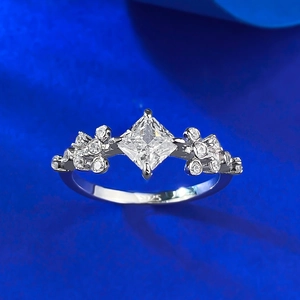 Elegant S925 sterling silver ring with princess cut cubic zirconia on blue silk fabric
