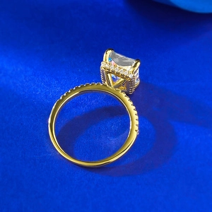 Luxurious gold ring with 8x10mm radiant cut high carbon diamond on blue textured background