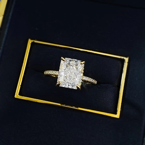 Luxurious S925 silver radiant cut diamond ring with gold finish in a navy jewelry box