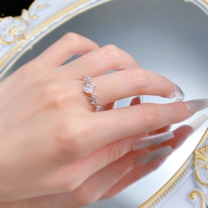 Close-up of S925 silver ring with princess cut diamond worn by model reflected in a mirror