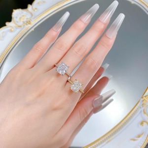 On-hand display of Radiant cut silver rings in gold and silver finishes with halo setting