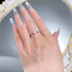 Close-up of S925 silver princess cut ring with floral side stones on a model's hand