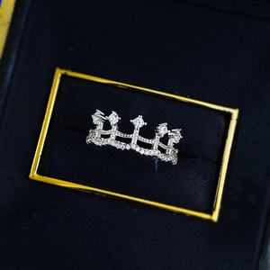Elegant silver crown ring with sparkling pavé diamonds on a black velvet jewelry box