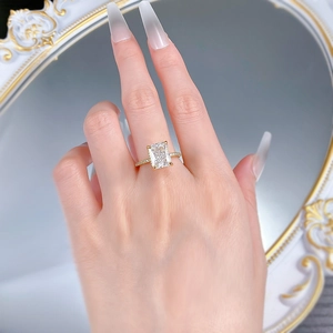 Close-up of radiant cut high carbon diamond ring on hand with vintage mirror background