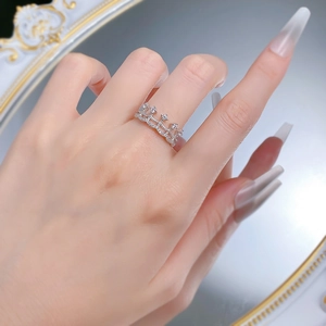 Detailed view of silver crown ring with zircon pave setting and double row diamond accents