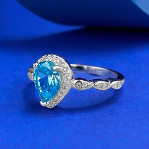 Elegant S925 silver halo ring with pear-cut blue gemstone and brilliant diamond accents