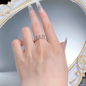Detail of silver crown ring with cubic zirconia worn by model on vintage mirror background