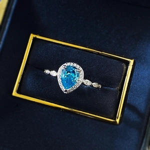 Elegant S925 silver ring featuring a 6x8mm pear-cut blue gemstone in a luxury jewelry box