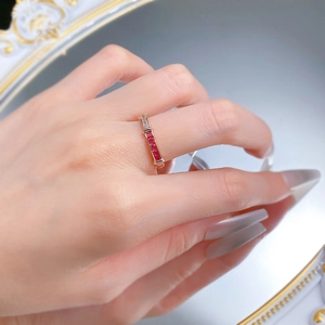Detail of S925 silver ring featuring red stones and white zircons on a gold-plated band