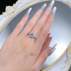 Elegant S925 silver ring featuring a pear-cut blue gemstone with halo diamonds