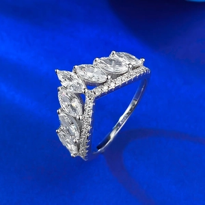 Macro shot of V-shaped S925 silver ring with marquise-cut stones on blue velvet