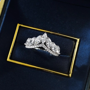 Elegant crown-shaped marquise-cut silver ring with accent diamonds on a blue velvet box