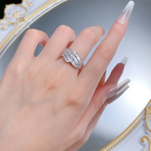 Detailed view of baguette-cut zircon stones on a luxury silver ring worn on a hand