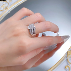 Macro detail of luxury silver ring with triple baguette-cut zircon rows on finger