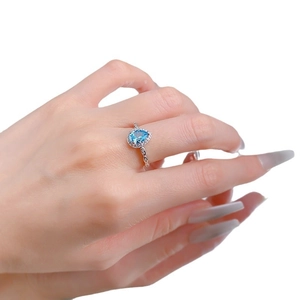 Elegant S925 silver ring featuring a pear-cut blue gemstone with sparkling side accents