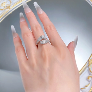 On-hand display of silver S-shape crossover ring set with sparkling white cubic zirconia