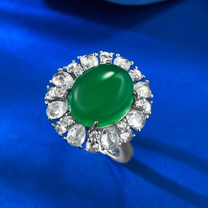 Macro view of oval green chalcedony ring with double-layered sparkling crystal halo