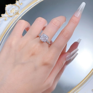 S925 silver ring with 10x10mm cushion cut diamond held against a vintage mirror