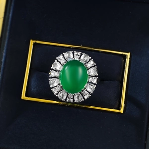 Macro view of a 925 silver ring featuring a large oval green chalcedony and zircons