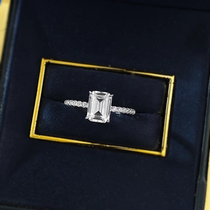 Elegant emerald-cut rectangular diamond ring in s925 silver on a velvet jewelry box