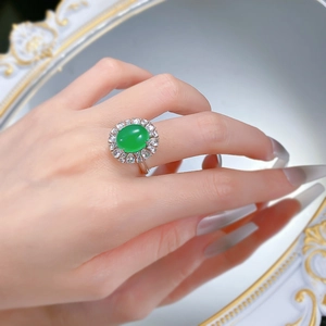 On-finger view of 925 silver ring with large oval green chalcedony and cubic zirconia
