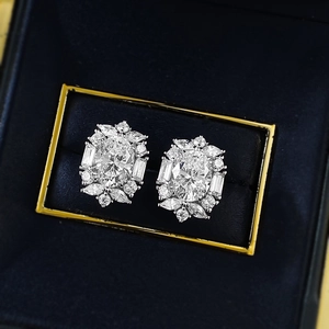 Elegant 7x9mm oval faux diamond stud earrings with silver claw setting in black jewelry box
