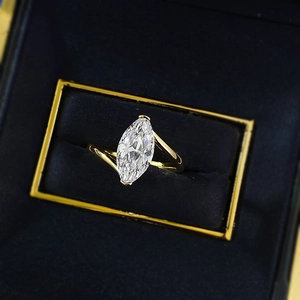 Close-up of a marquise-cut yellow gold ring presented in a luxury black velvet jewelry box