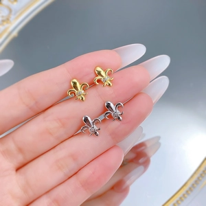 Close-up of S925 silver fleur-de-lis stud earrings with tiny zircon inlays