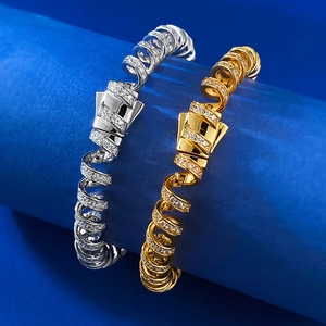 Macro detail of S925 silver spiral bracelet with full diamond pavé inlay on blue podium