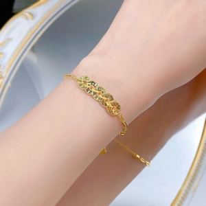 Elegant gold five-coin bracelet featuring Chinese traditional charms on O-chain link