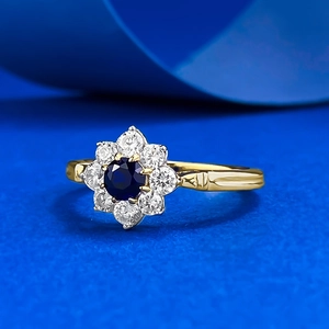 Elegant S925 silver sunflower ring featuring a blue gemstone and golden finish