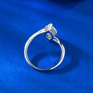 Macro side view of silver ring featuring a round solitaire stone in four-prong setting