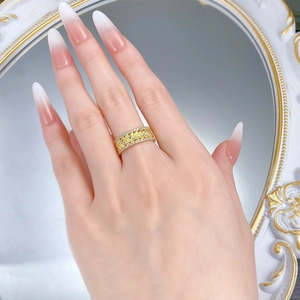 Macro shot of S925 silver wheat pattern ring with gold finish and sparkling zircon border