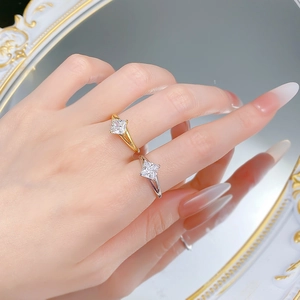 Detail showing princess cut square diamonds and split shank rings in gold and silver finish