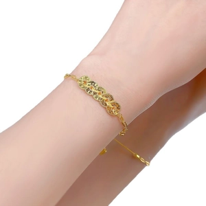 Golden bracelet featuring five Chinese ancient coins on a classic O-link chain worn on wrist