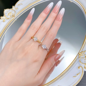 Close-up of minimalist gold and silver S925 rings with diamond cut stones on model hand