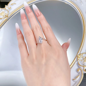 Close-up of marquise-cut marquise high-carbon diamond ring on hand with silver band