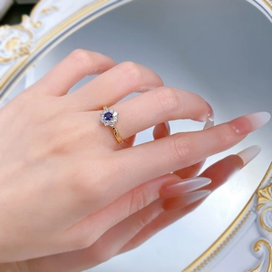 Detailed view of an S925 silver sunflower ring with blue sapphire and gold plating