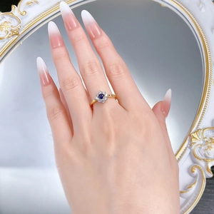 Close-up of S925 silver blue sunflower ring with gold finish on a hand