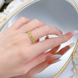 Detail of S925 silver lace ring with purple gemstones and golden brushed texture finish