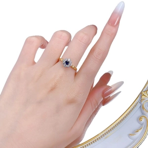 S925 silver gold-plated ring featuring a 4mm blue sun flower design worn on a hand